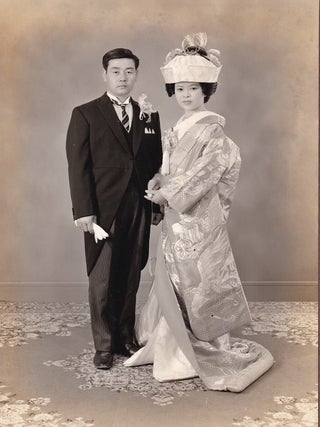 Japanese Traditional Weddings, Real Photographs; 7 in traditional Kimono costume, and 2 Western style dress. A collection of 9 couple photographs, all mounted in individual folders, with tissue guards: Meiji Kinenkan Photography Department Song Jie; Nobuyuki Nakai Wedding Yujuriki Photo Garo 4, Bibai City; Tokyo Yotsuya Station National Electric Railway Shufu Kaikan Photo; Tsuchiura Keisei Hotel; Saito Photo Studio Takai; Shinjuku Station Building Photography Rainbow Hall; Meiji Kinenkan; Y. Miyauchi, Tokyo; Kanagawa Prefectural Labor Hall Photo Department Nozawa Photo Gallery.
